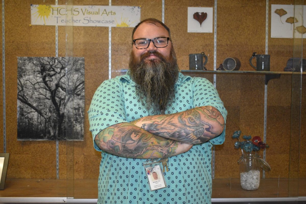 Art teacher Eric Bolander pictured in front of the art show case.