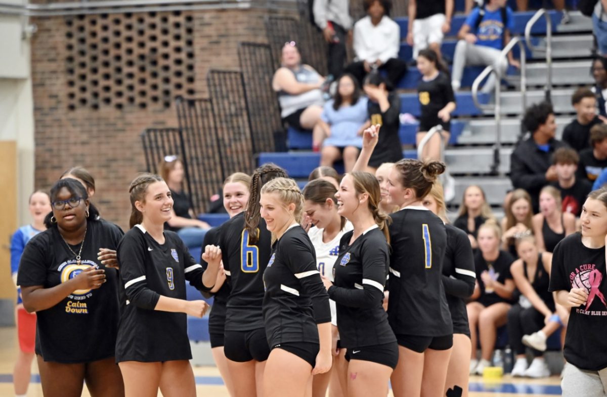 Girls' Volleyball celebrates their first district win of the season against Sayre.