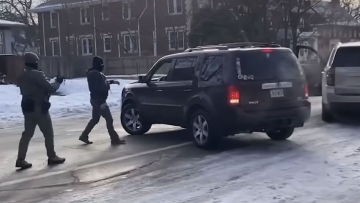 ICE confronting Renee Good in her car.